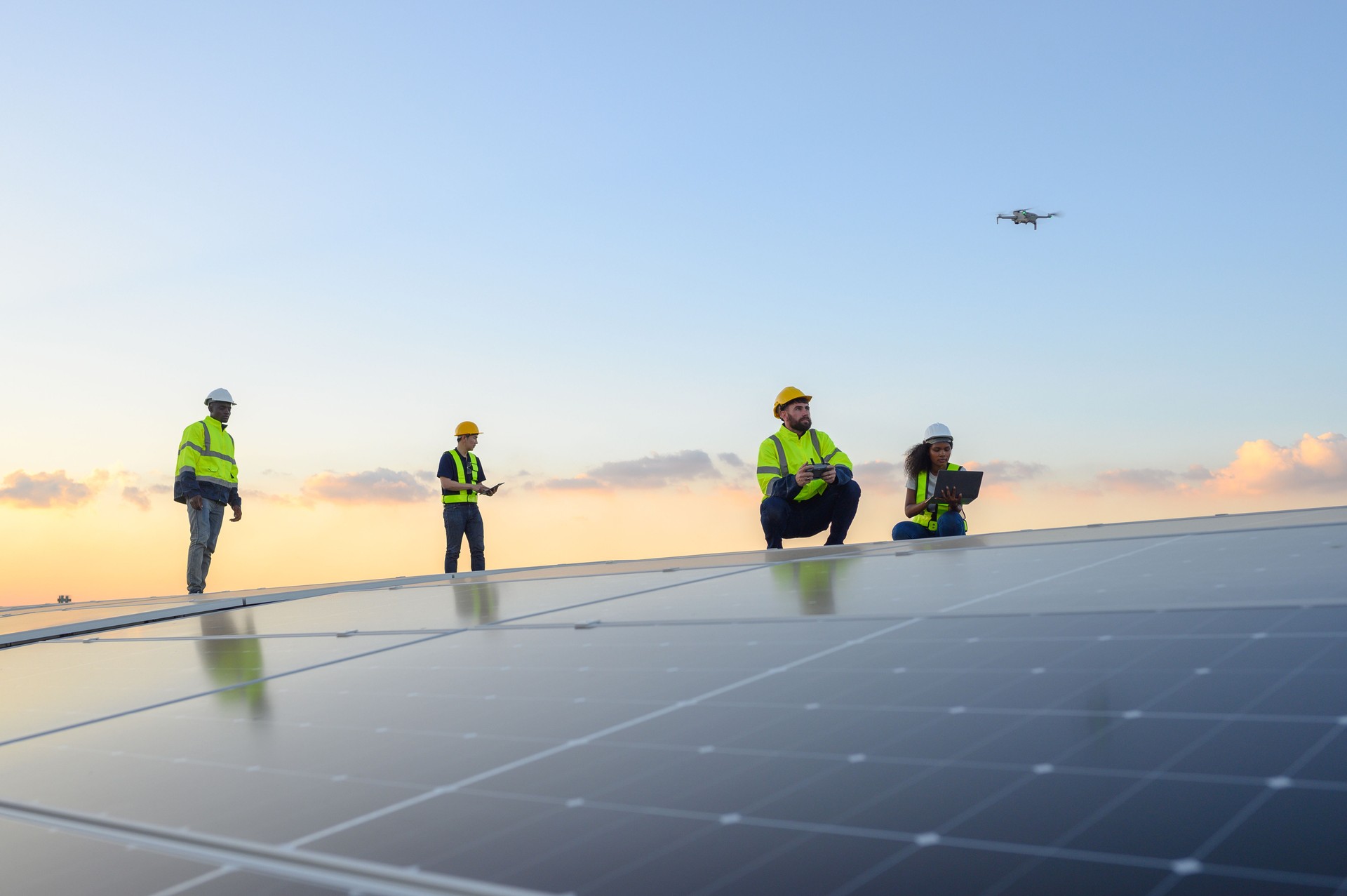 A team of engineers flies a drone to plan the installation of an outdoor solar panel system. Installing solar cells on the roof Solar panels on the roof Workers install eco-technology solar power plan